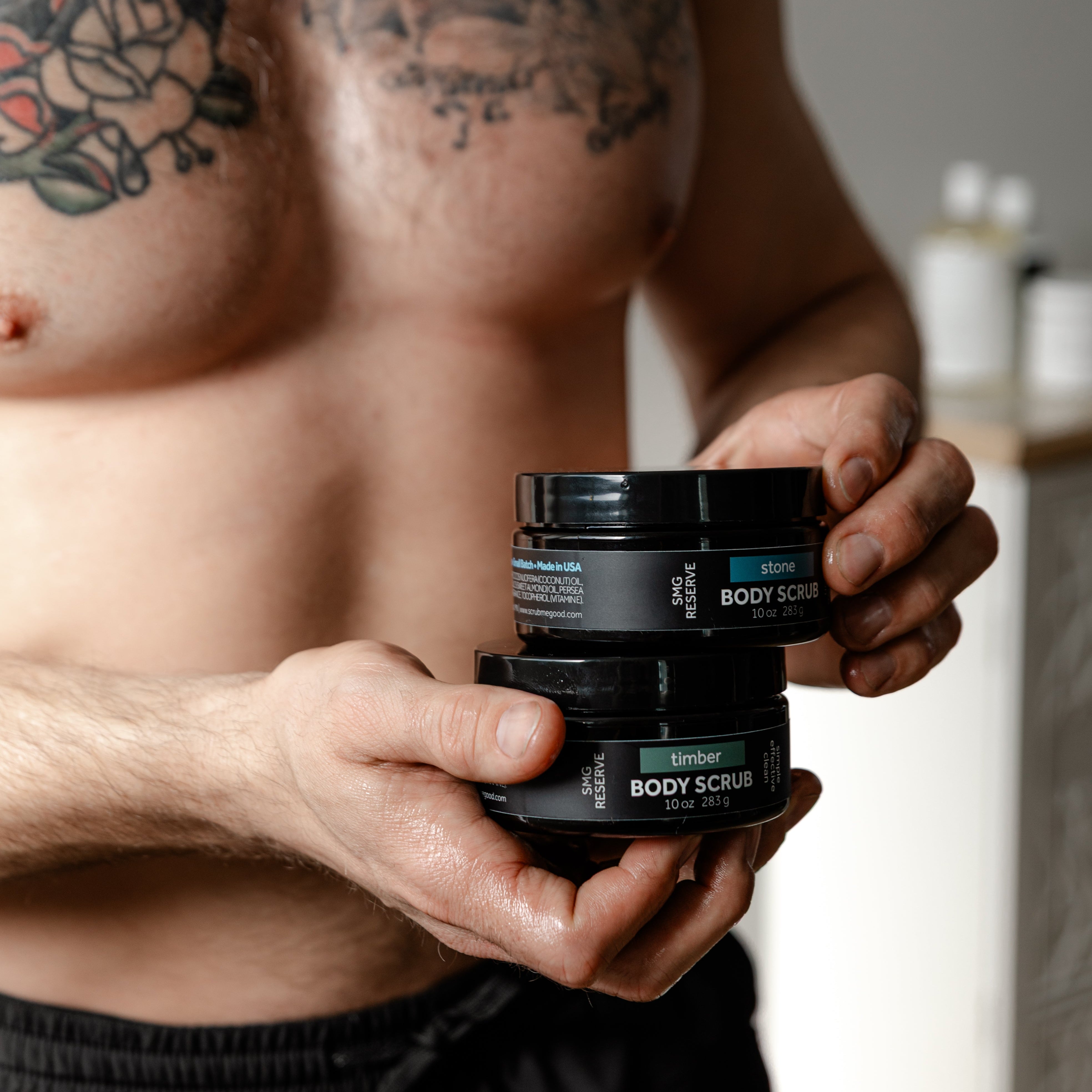 man holding SMG Reserve Body Scrubs