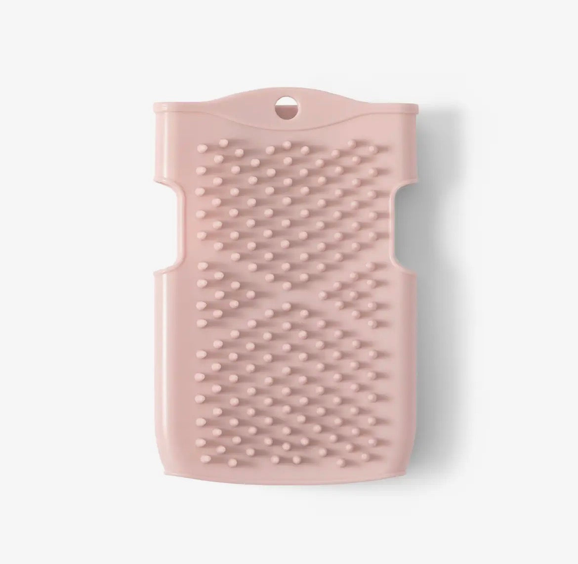 Pink textured silicone scrubber on a white background