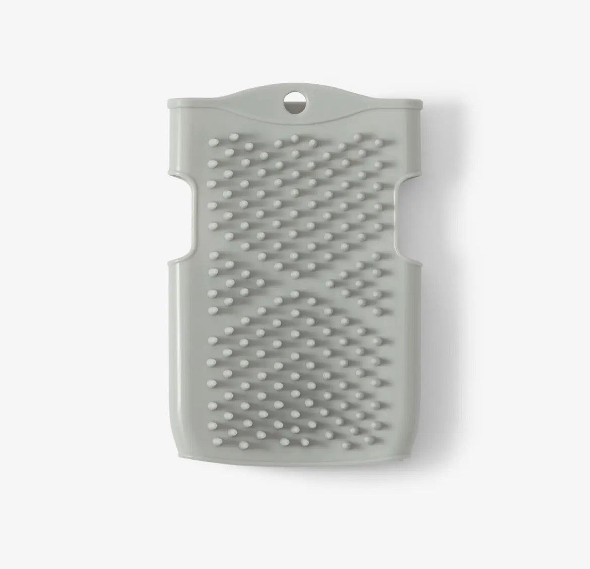 Gray silicone hand scrubber on a white background