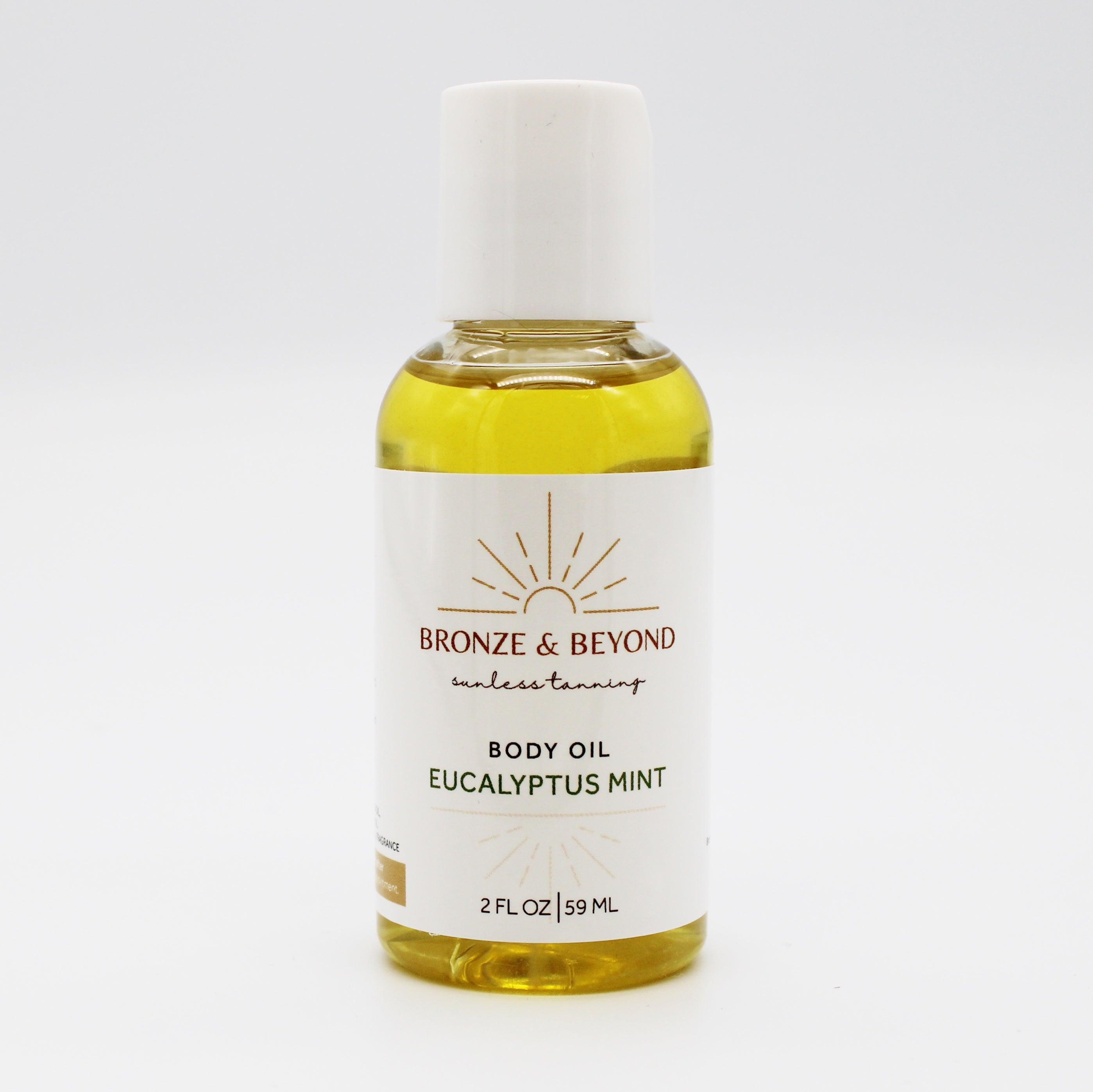 Bottle of Bronze & Beyond tan safe Eucalyptus Mint body oil on a white background