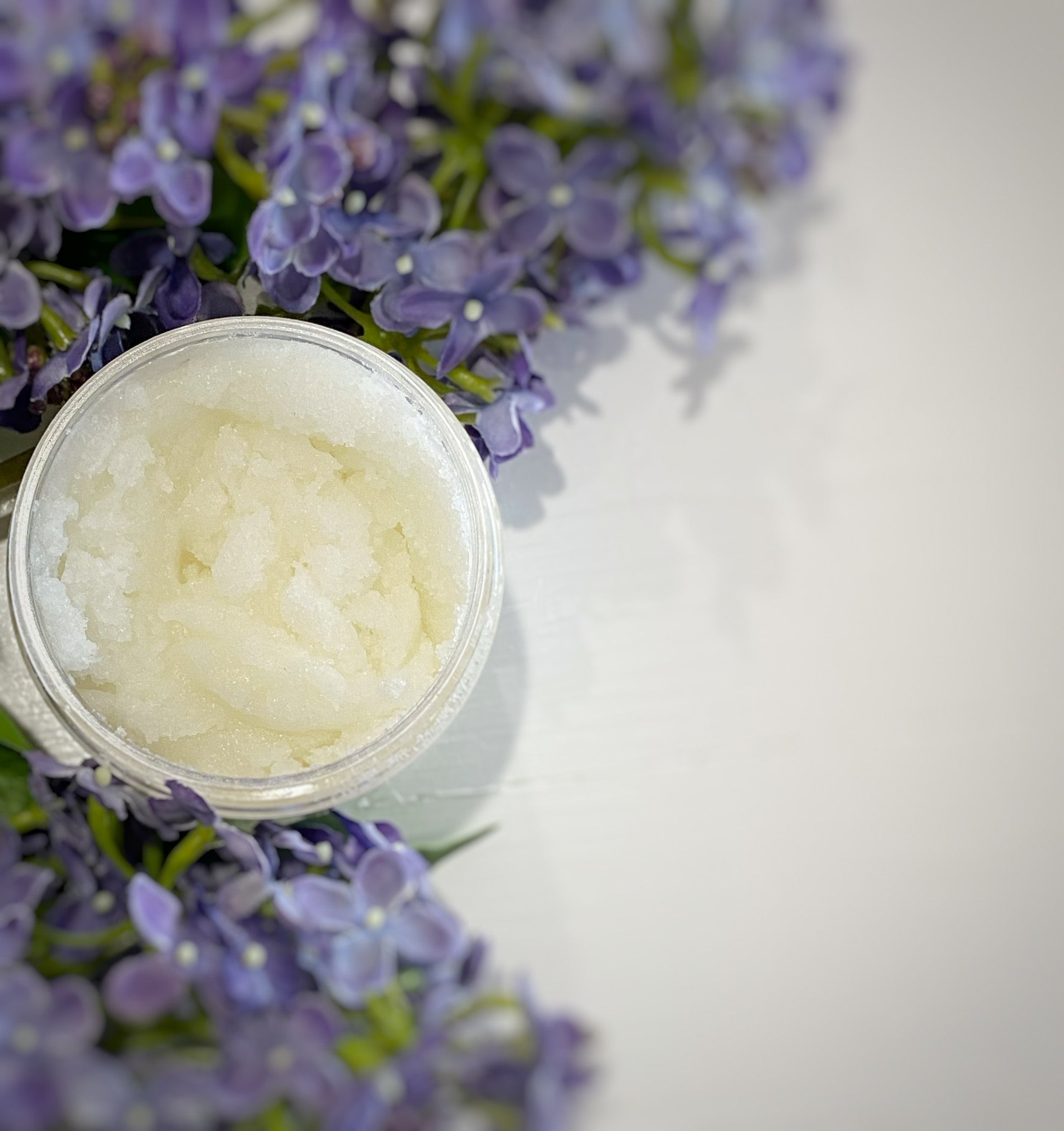 Jar of Spring Lilac Sugar Scrub with fine sugar crystals