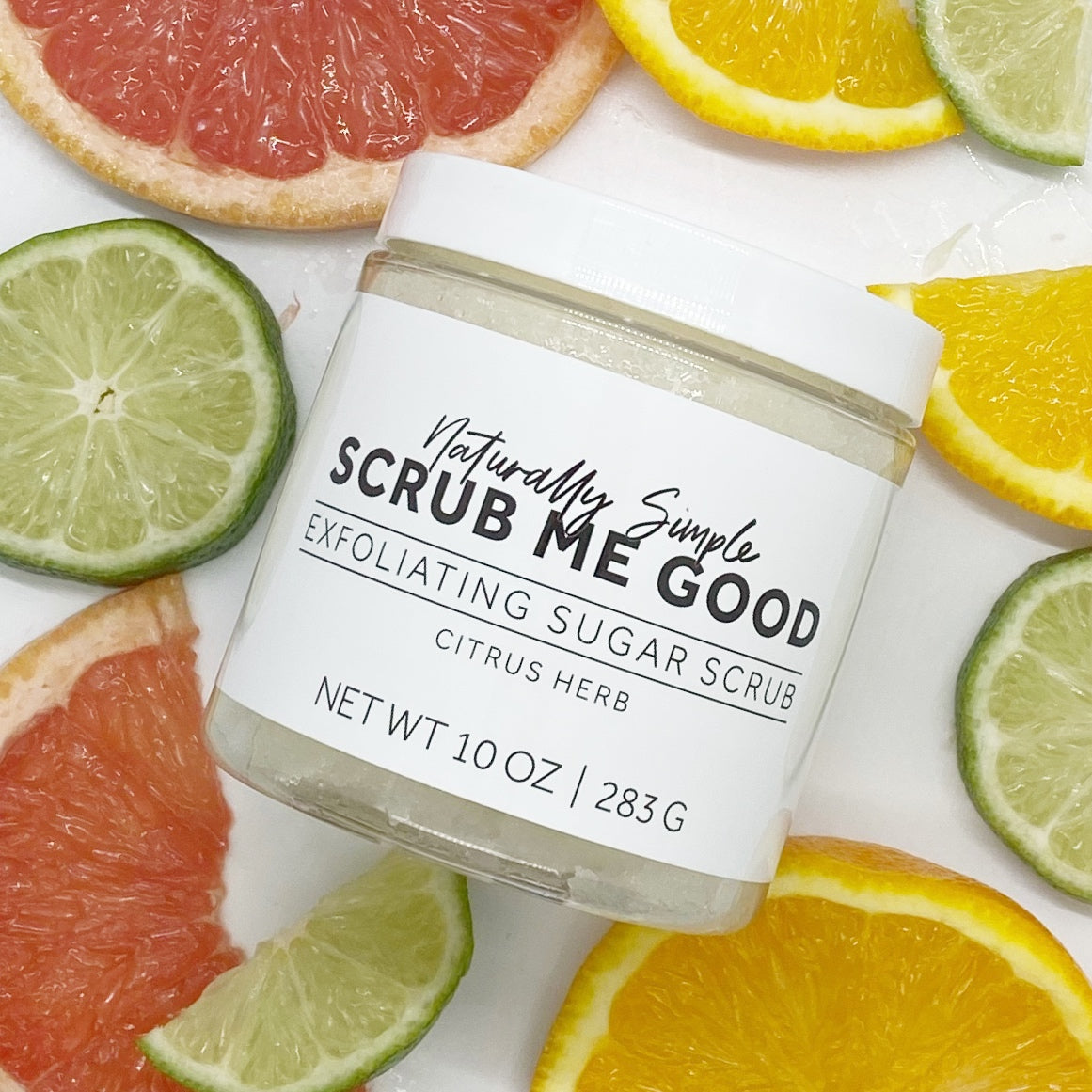 Exfoliating scrub for smooth, refreshed skin, surrounded by citrus fruit