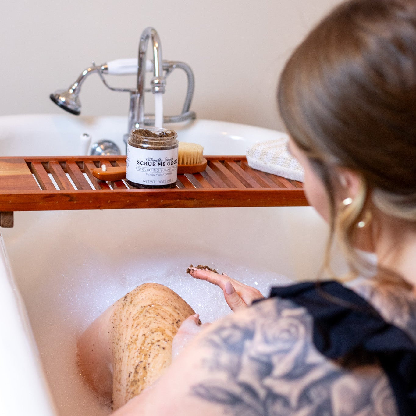 woman in bath using Scrub Me Good Brown Sugar Coffee sugar scrub