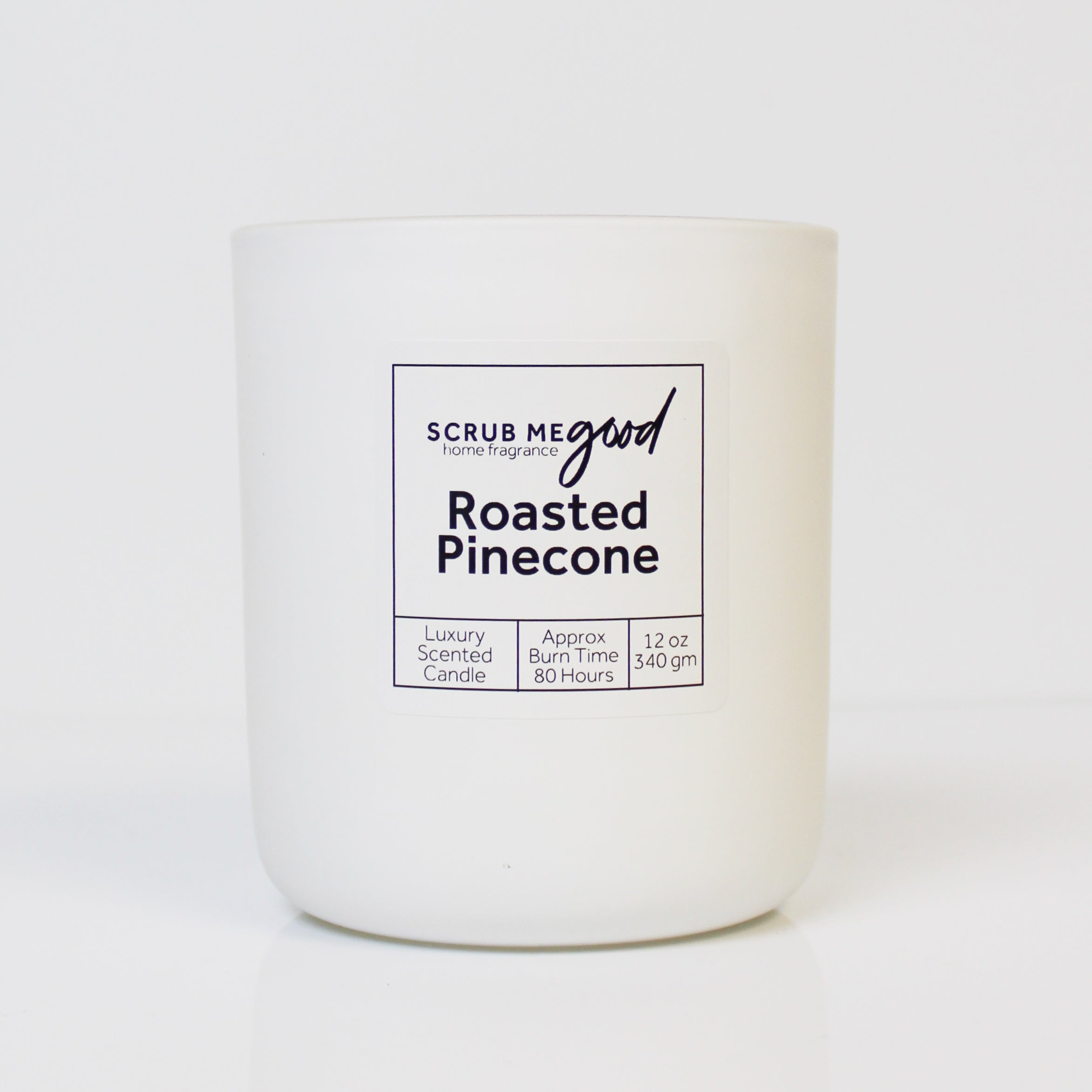 Scrub Me Good Roasted Pine Cone 12 oz wooden wick candle with soft pine, vanilla, and sandalwood scent.