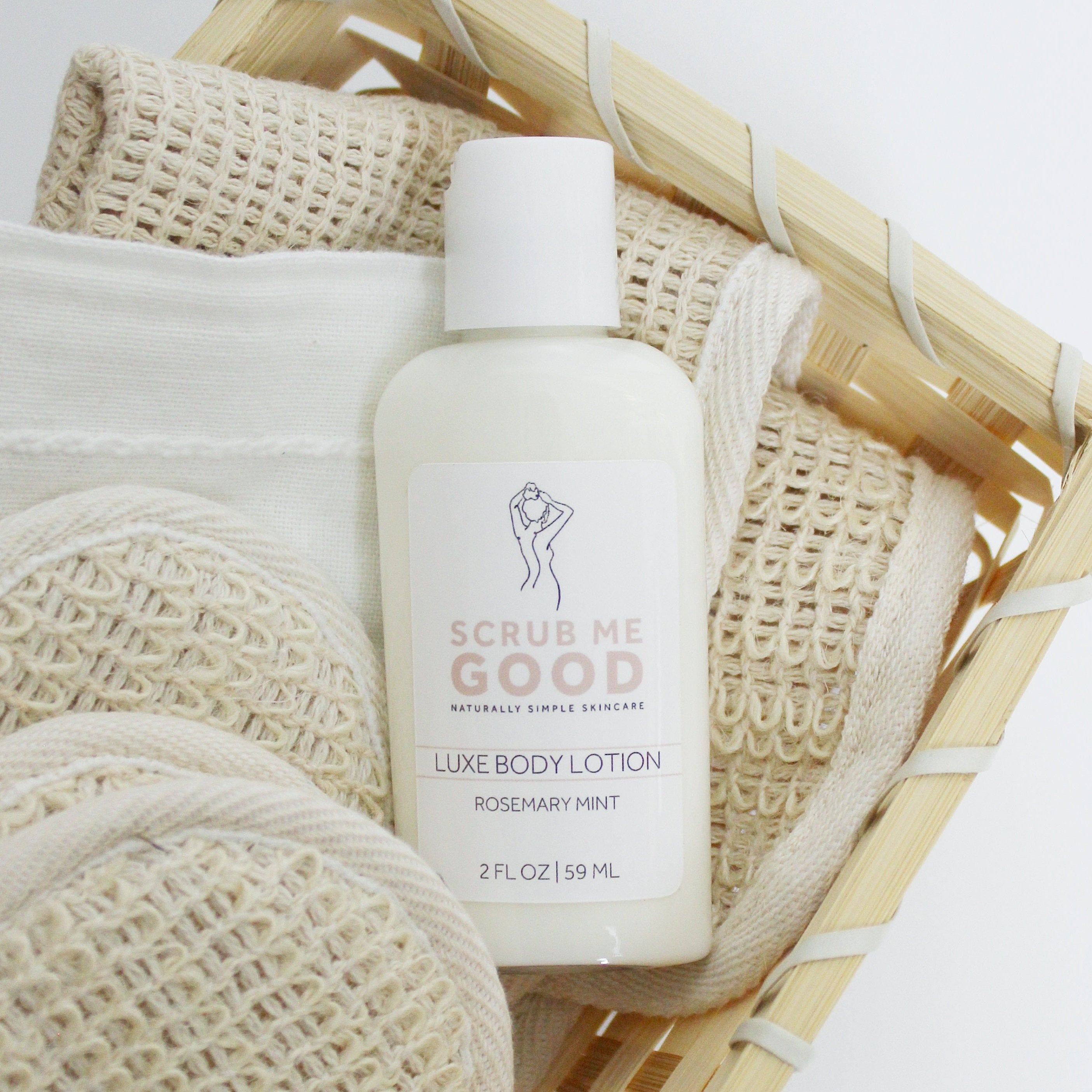 A clear plastic bottle with a pump dispenser labeled 'SCRUB ME GOOD Luxe Body Lotion Rosemary Mint' containing white lotion.