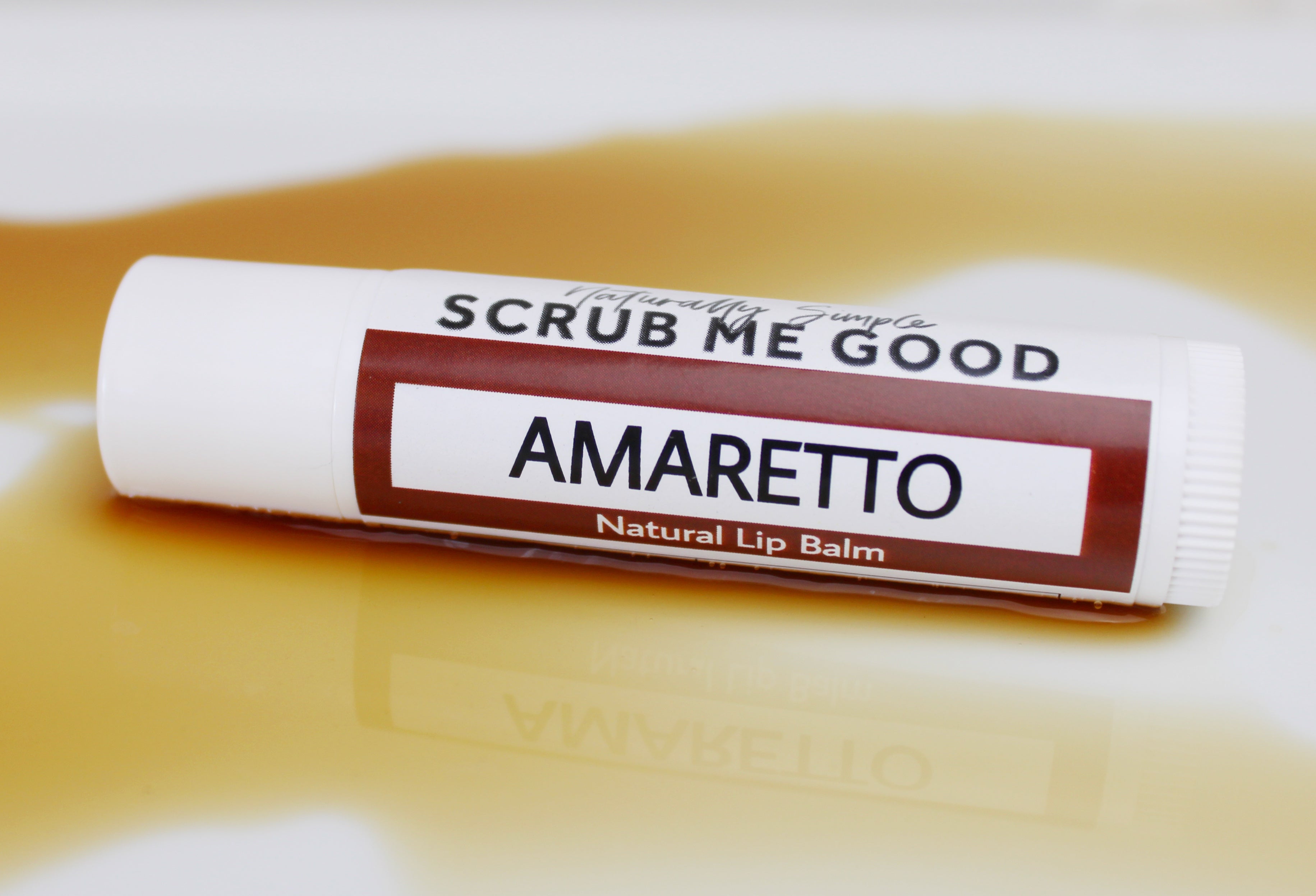 amaretto lip balm in puddle of amaretto