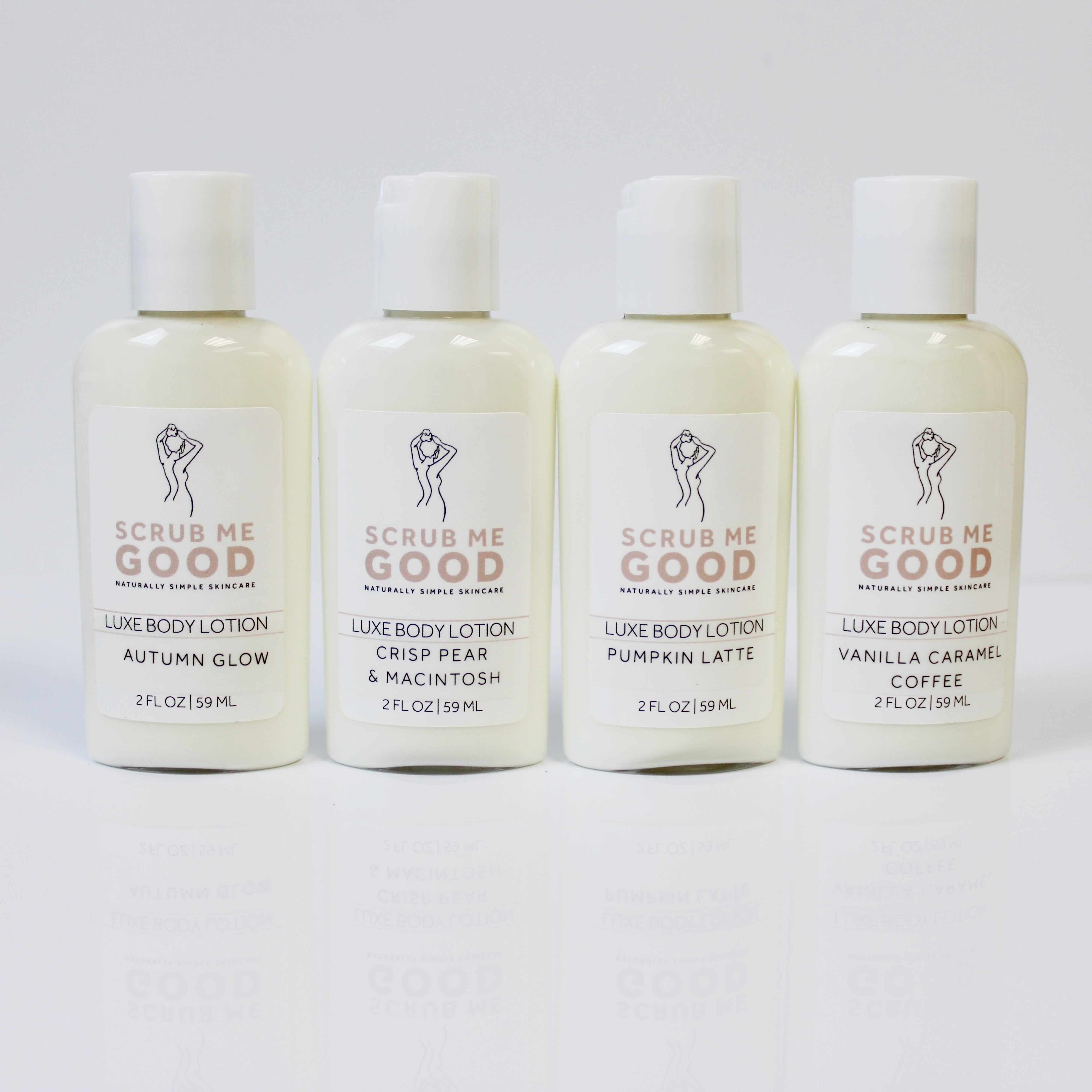 Four bottles of Scrub Me Good body lotion on a white background