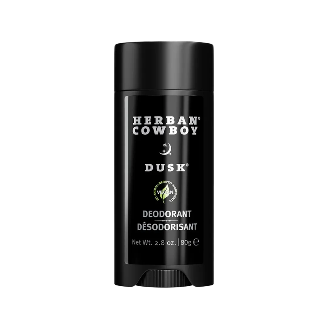 Herban Cowboy Dusk stick deodorant for men with sandalwood, sage, and cedar leaf on a neutral background