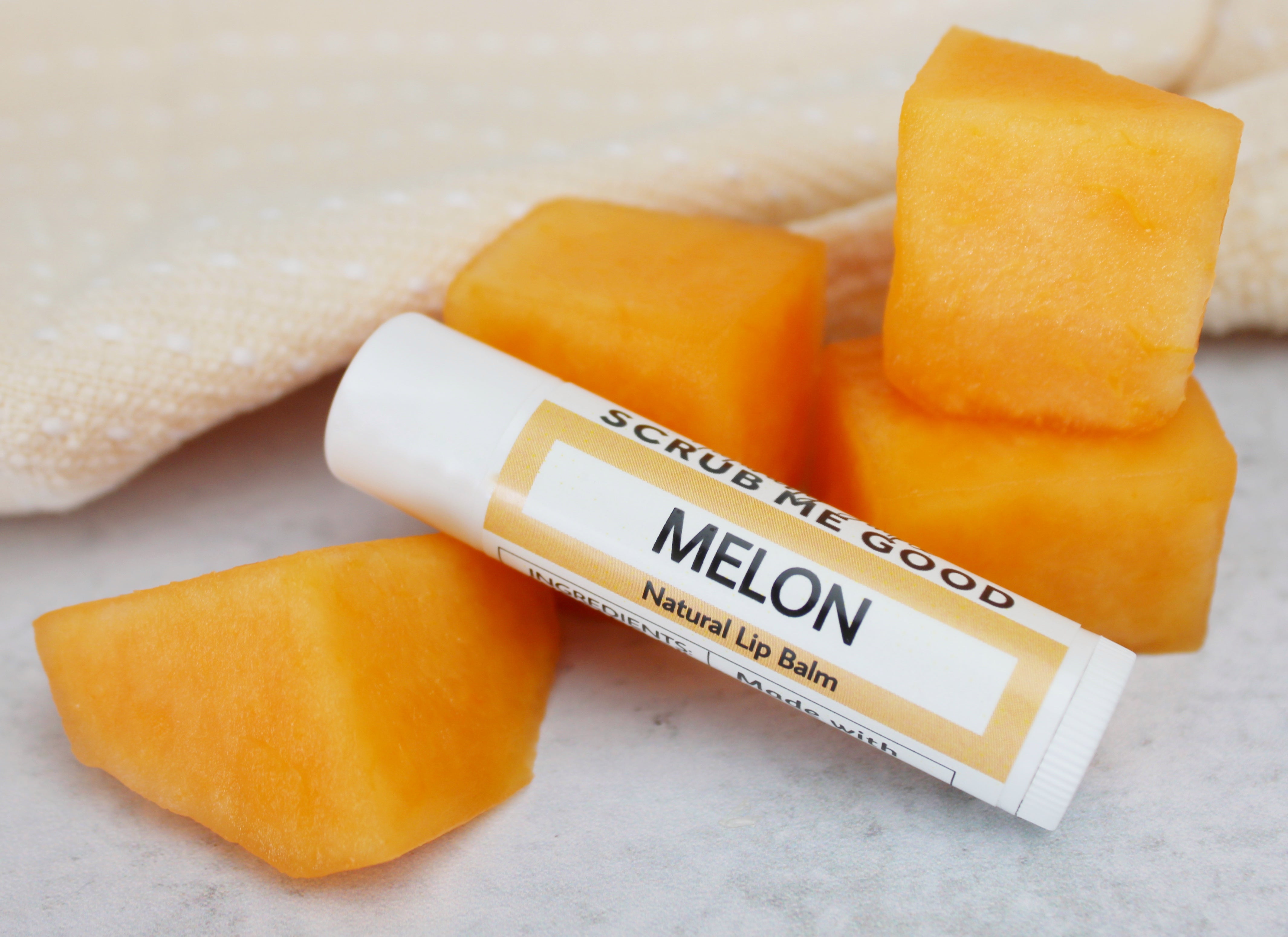 melon lip balm pictured with cut melon