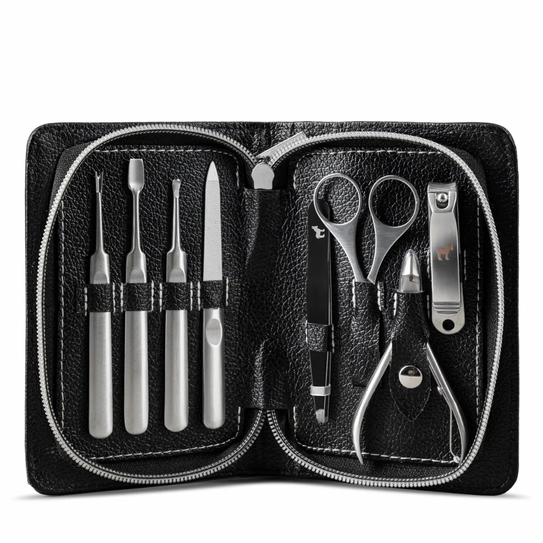 Men’s manicure kit displayed in a leather case with grooming tools arranged on a neutral stone surface.