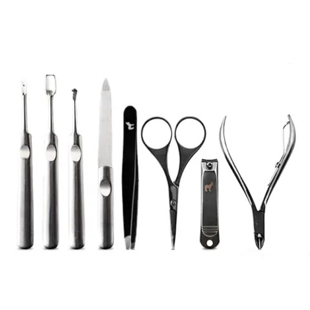 Stainless steel men’s manicure tools laid out individually on a white background, including nail clippers, scissors, tweezers, and cuticle tools.