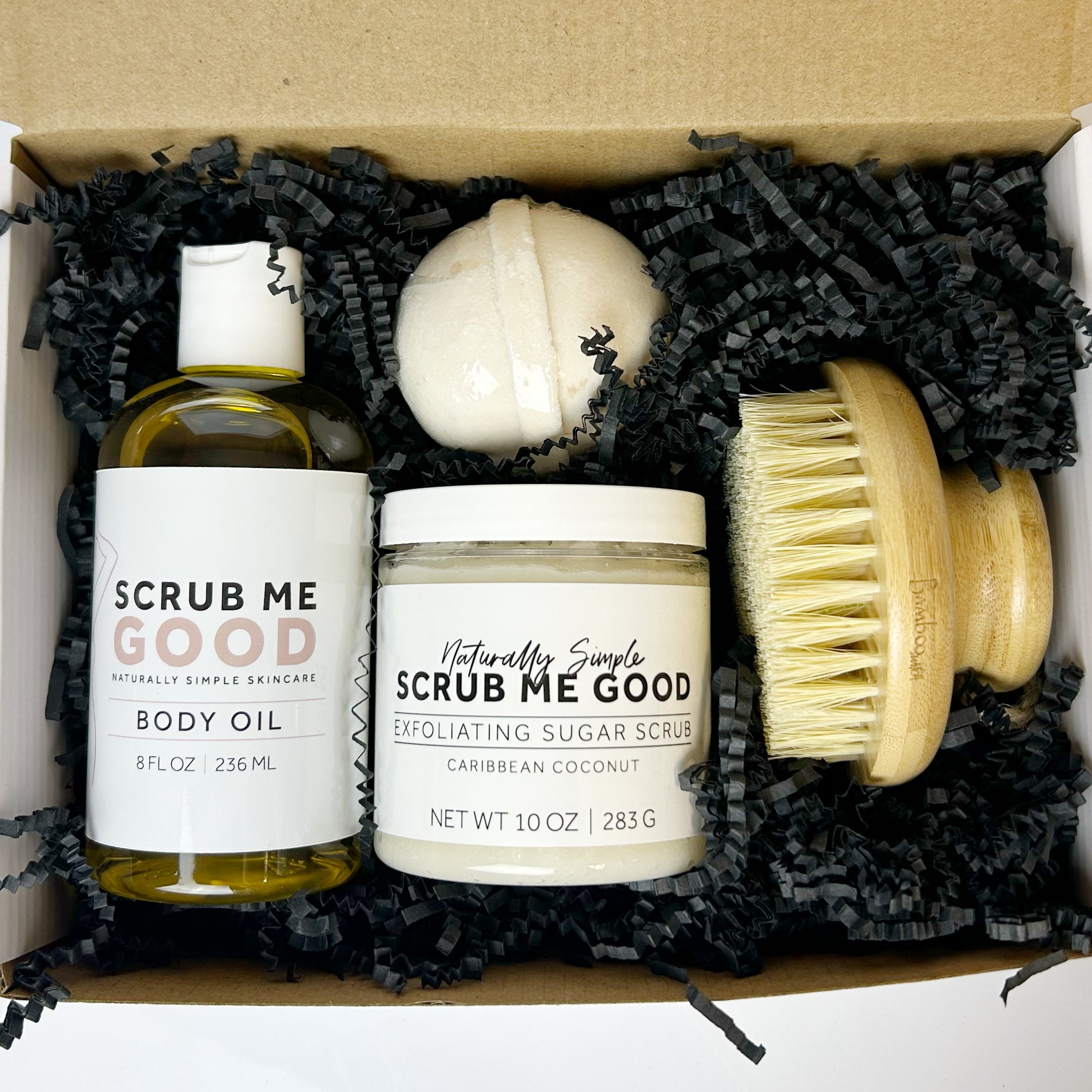gift bundle of scrub me good products and a dry brush