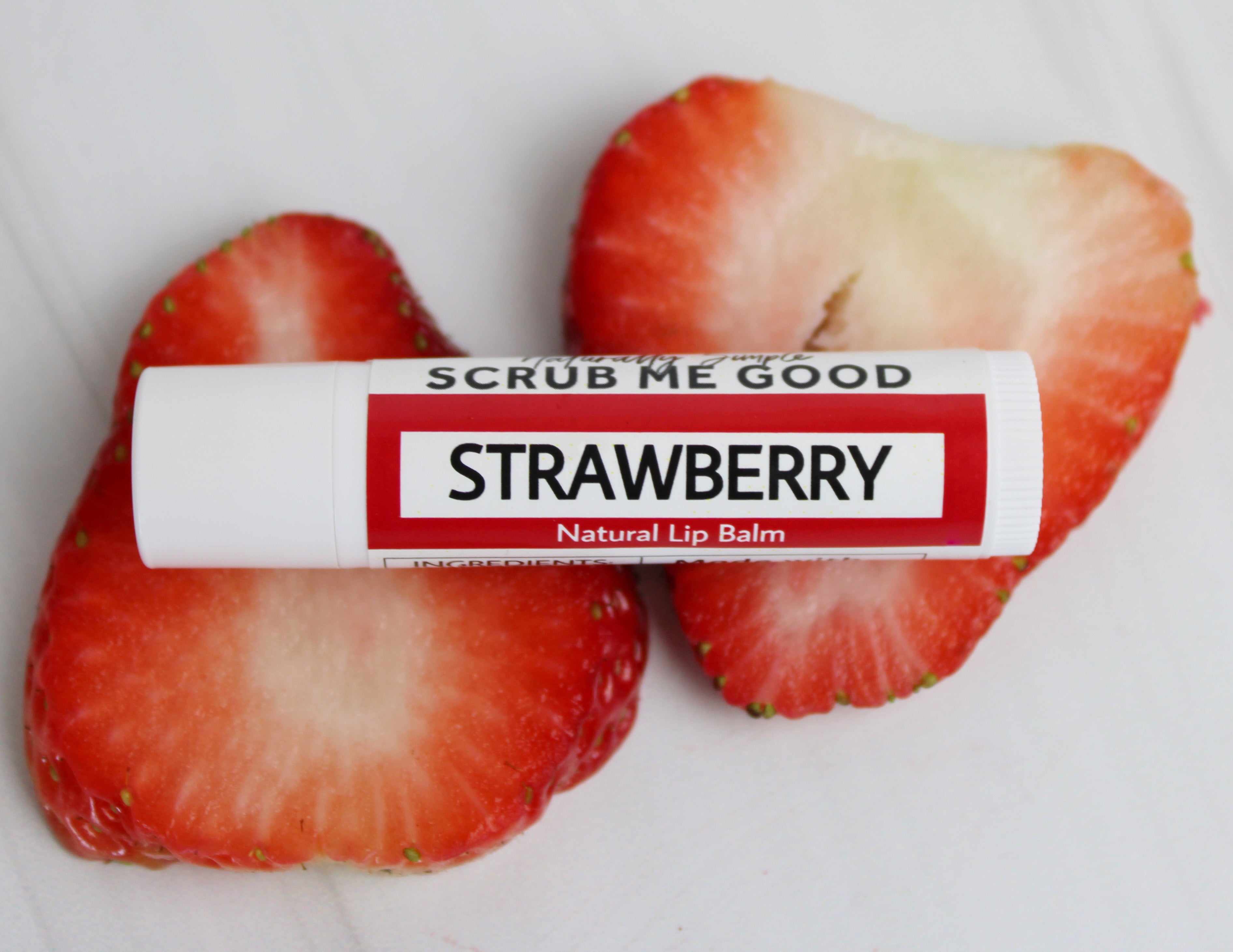strawberry lip balm laying on strawberry sclices