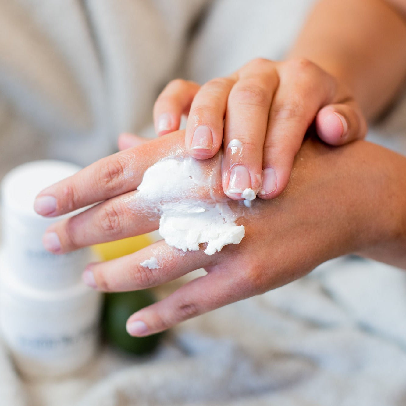 woman rubbing whipped body butter on her hands