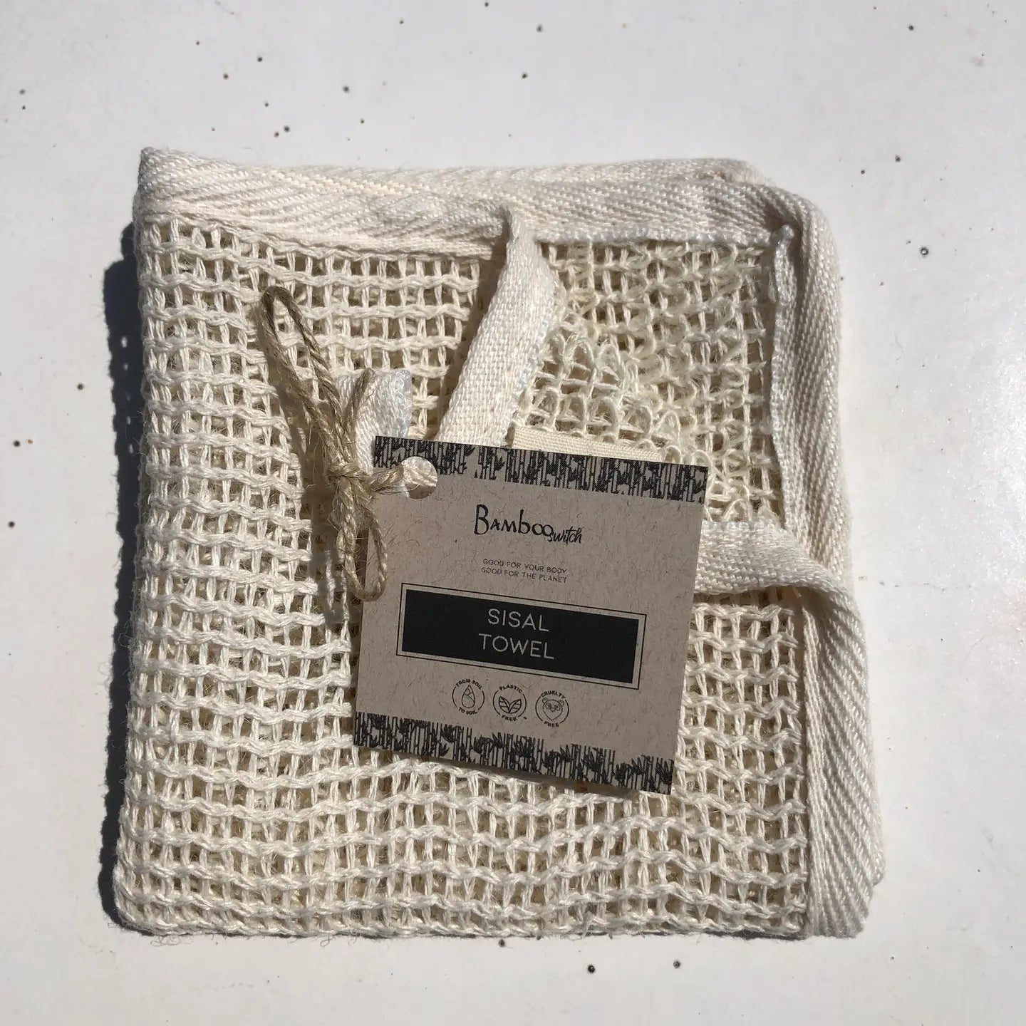 Sisal towel with a label on a light gray background