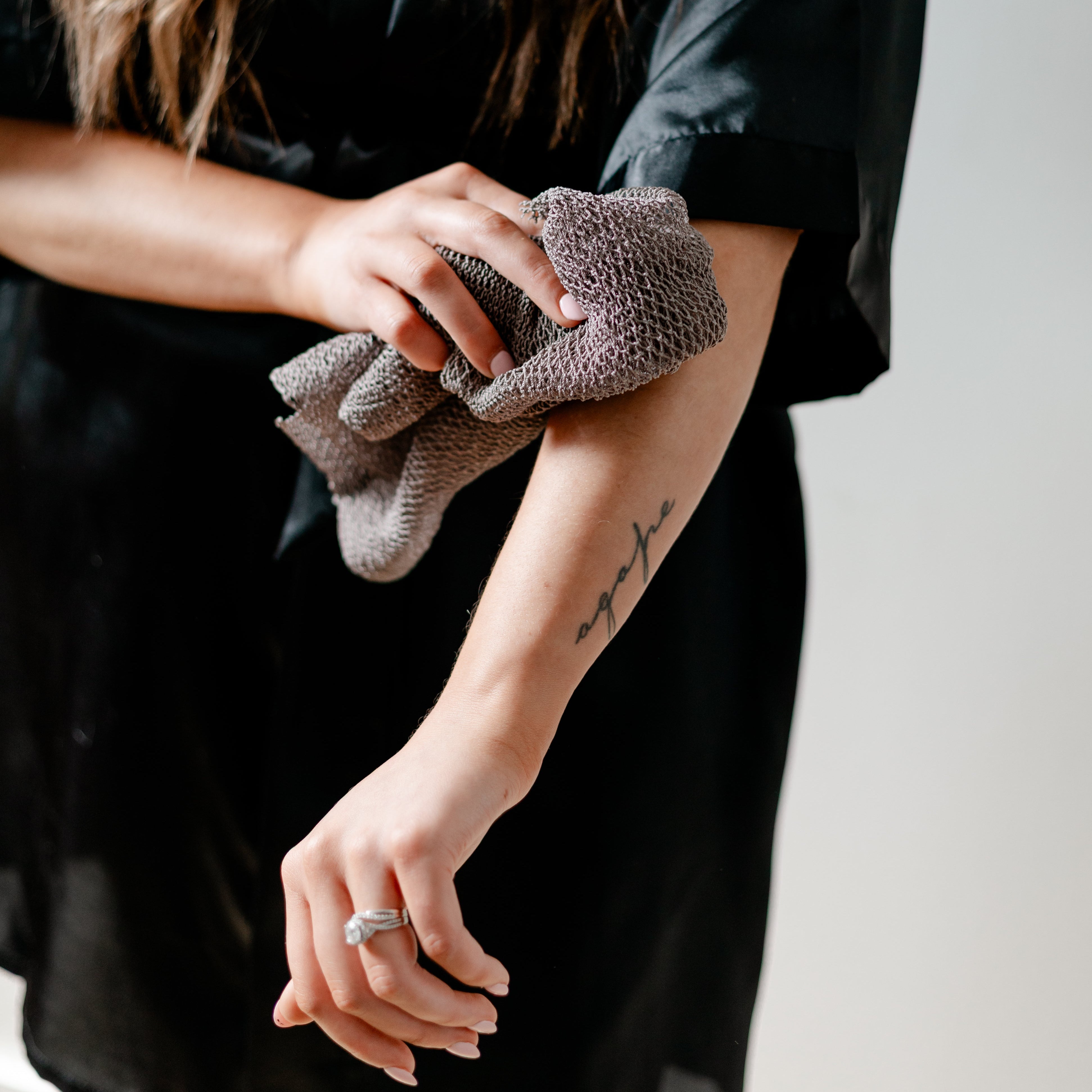 person using luv scrub on their arm