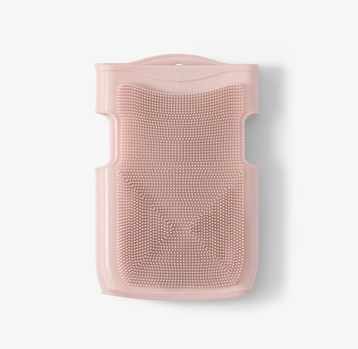 Pink silicone scrubber on a white background
