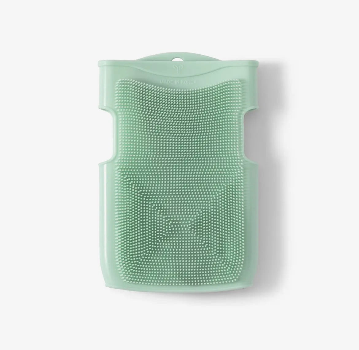 Green silicone scrubber on a white background
