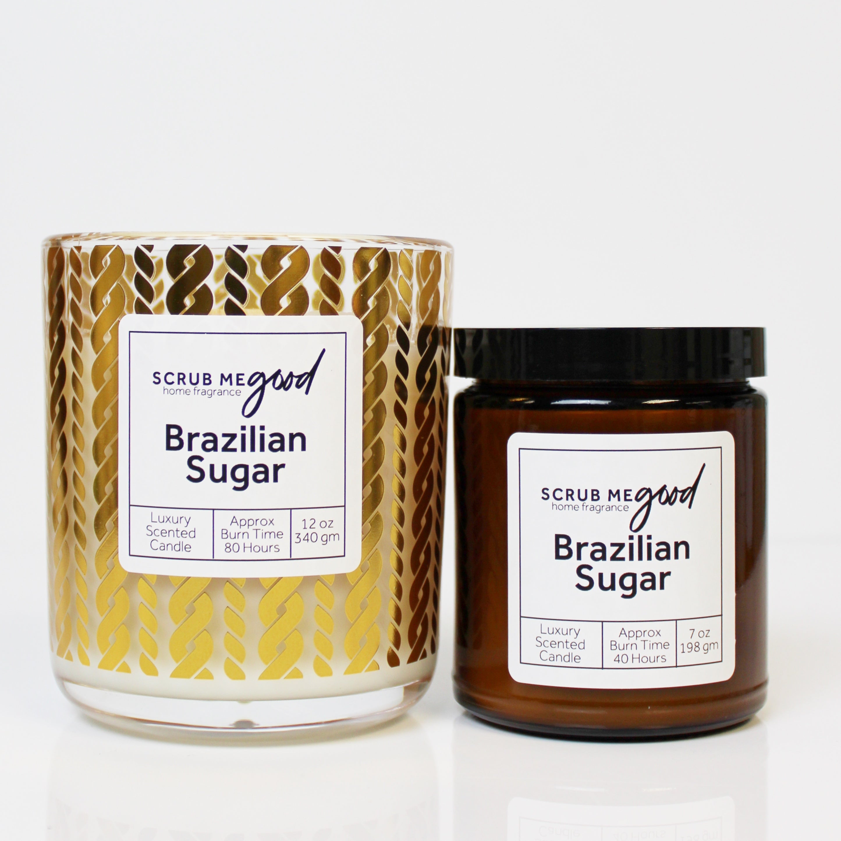 Scrub Me Good Brazilian Sugar wooden wick candles in two sizes, glowing with warm golden tones.