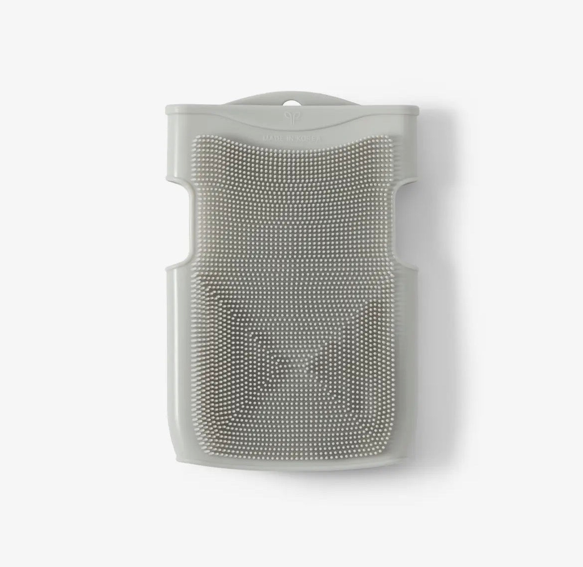 Silicone scrubber with bristles on a white background