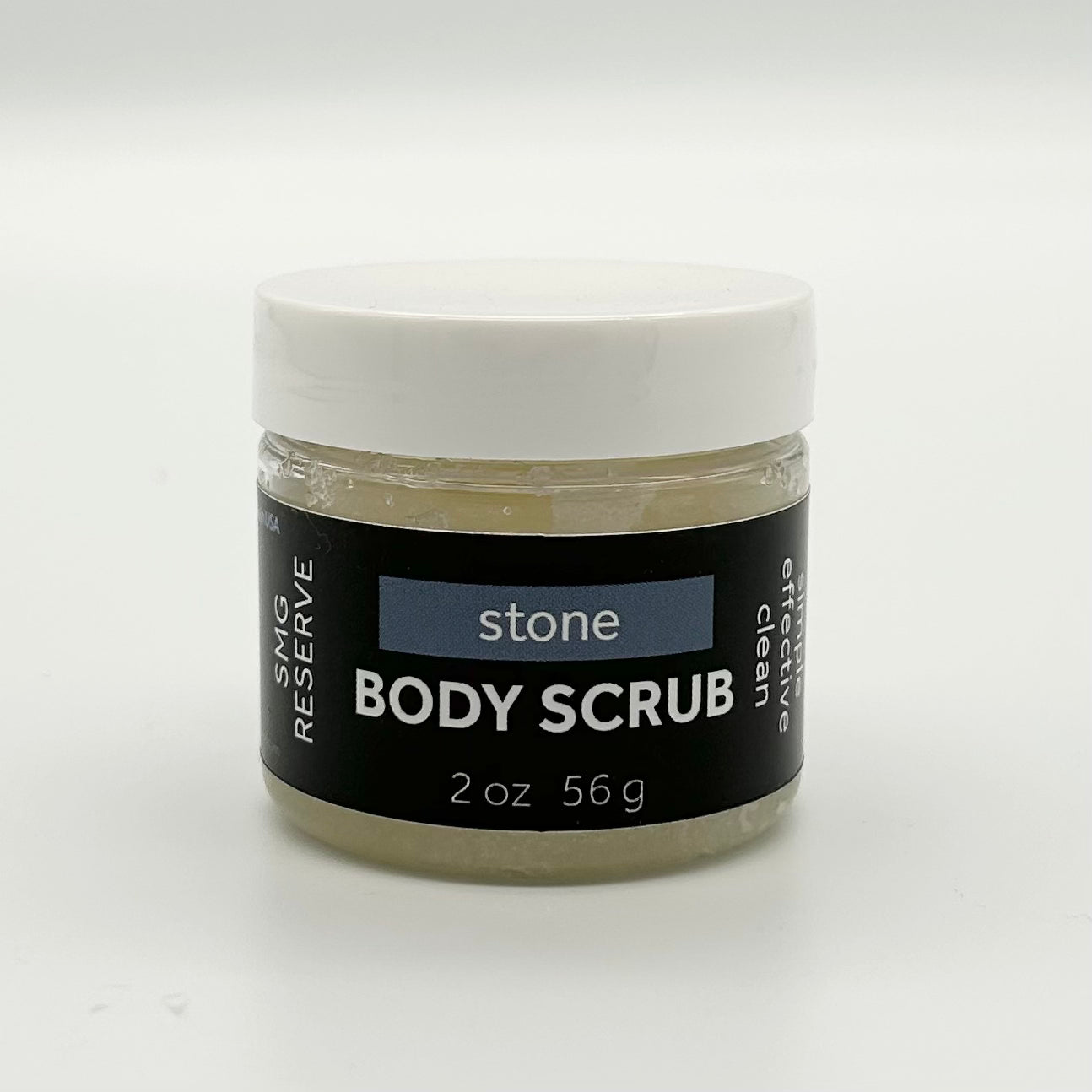 Jar of stone body scrub with a black label on a white background