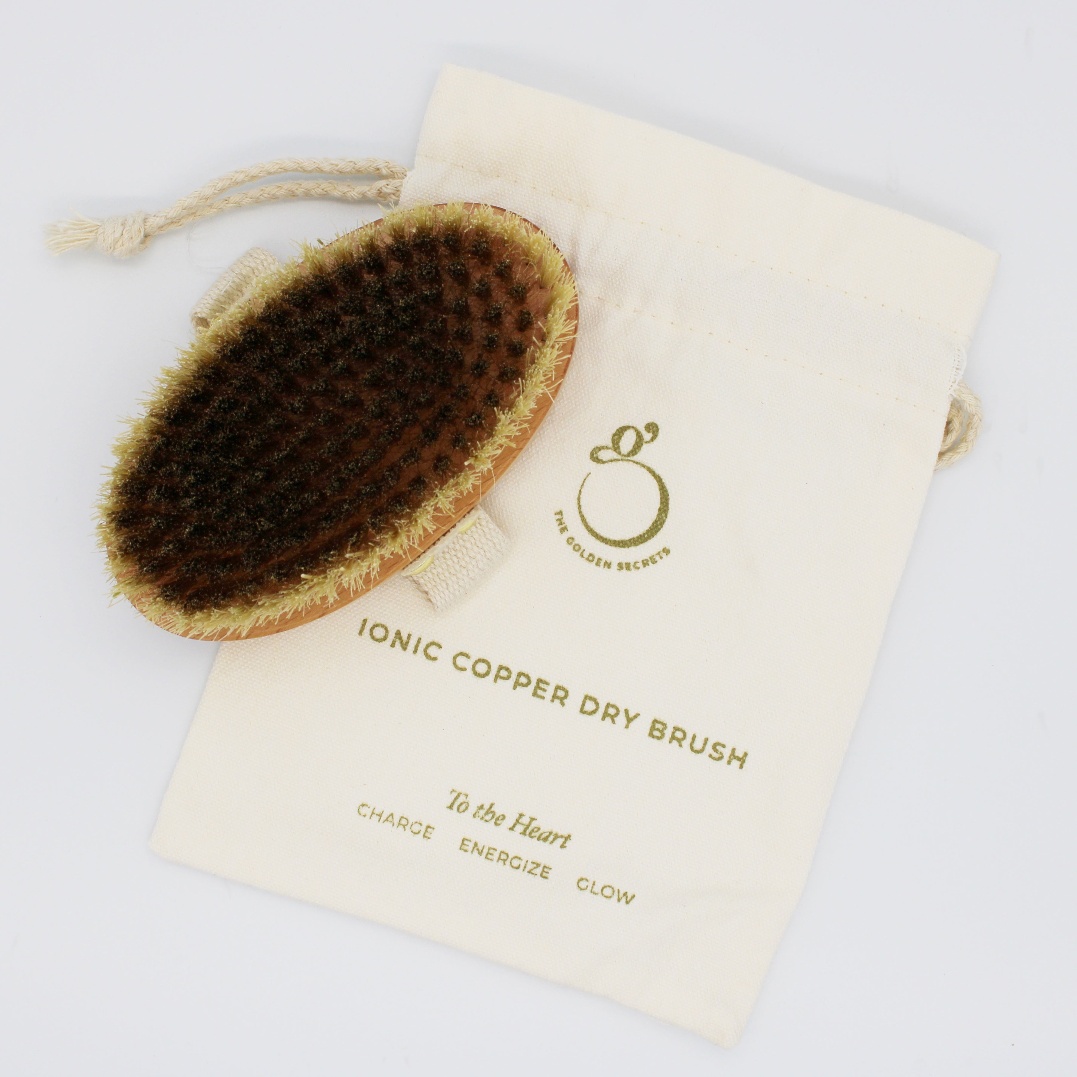 Ionic copper dry brush with a branded pouch on a white background